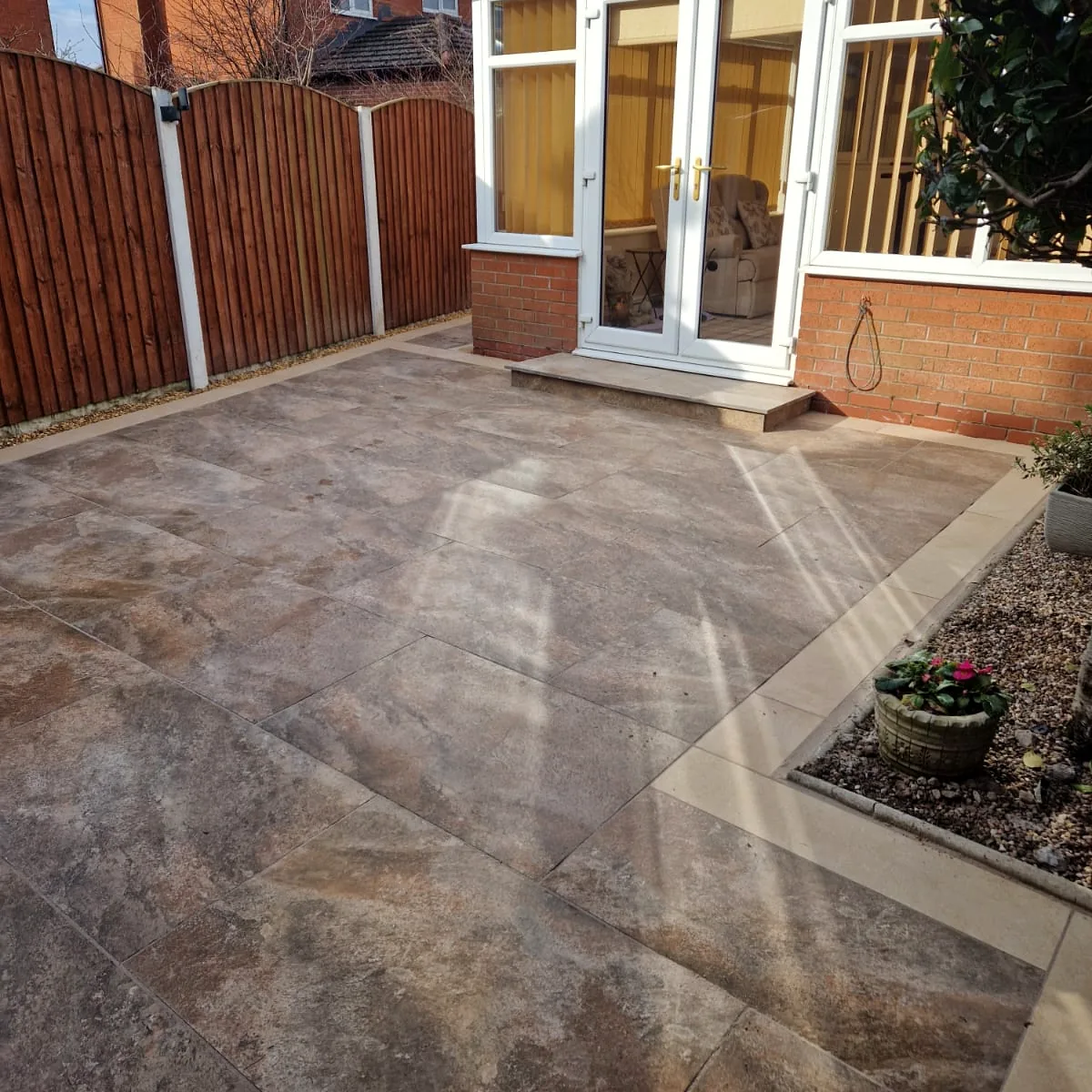 Warm stone-effect patio with contrasting border