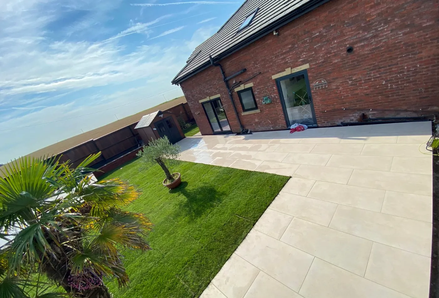 Landscaped garden with porcelain paths, lawn and planting