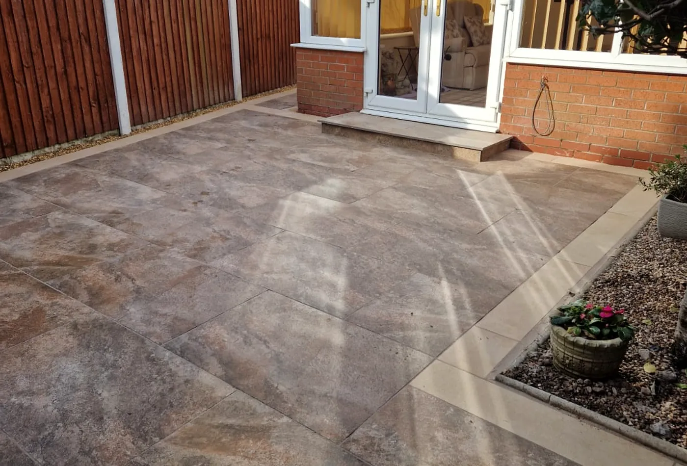 Warm porcelain patio with contrasting stone border